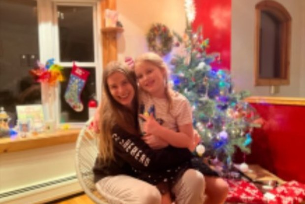 Robyn Lawley with her daughter in front of their Christmas tree.