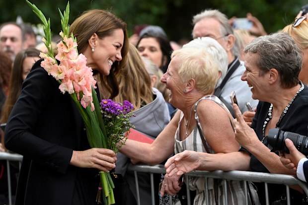 Kate, Princess of Wales reacts with a well-wisher as she and Prince William, view floral tributes left by members of the public, in memory of late Queen Elizabeth II, at the Sandringham Estate, in Norfolk, England, Thursday, Sept. 15, 2022. 