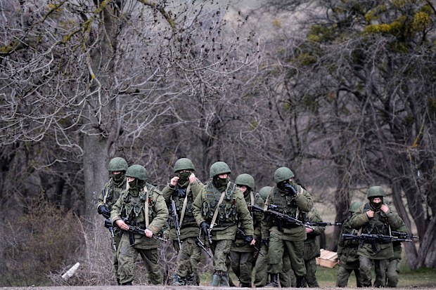 Russian soldiers patrol the area surrounding the Ukrainian military unit in Perevalnoye, outside Simferopol, on March 20, 2014