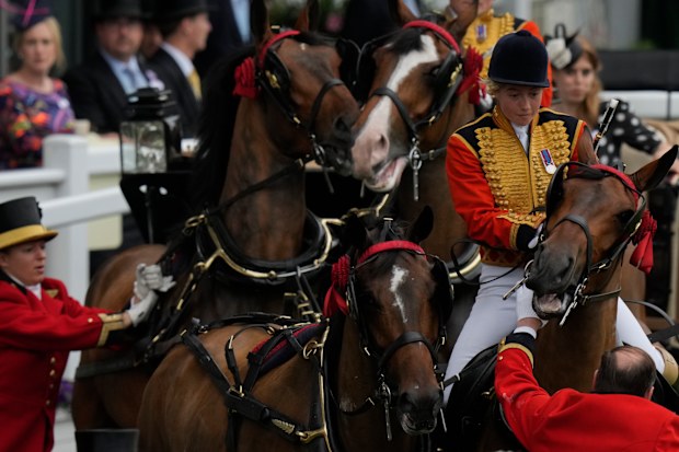 Princess Beatrice, at rear right, reacts as a mounted groom and other try to settle one of the horses leading her carriage on the fifth day of the Royal Ascot horserace meeting, at Ascot Racecourse, in Ascot, England, Saturday, June 18, 2022. (AP Photo/Alastair Grant)