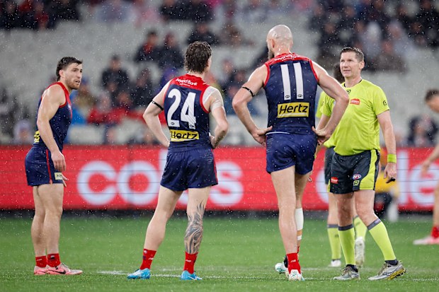 Melbourne players and AFL umpires were sent off due to lightning fears at the MCG.