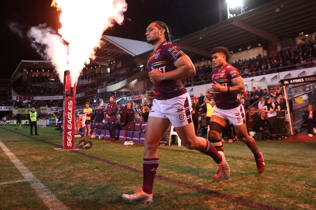 Manly Sea Eagles player Marty Taupau runs out in the rainbow jersey against the Roosters.