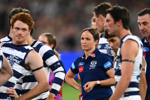 MELBOURNE, AUSTRALIA - MARCH 17: Daisy Pearce looks on as Cats head coach Chris Scott  speaks to his players  during the round one AFL match between Geelong Cats and Collingwood Magpies at Melbourne Cricket Ground, on March 17, 2023, in Melbourne, Australia. (Photo by Quinn Rooney/Getty Images)