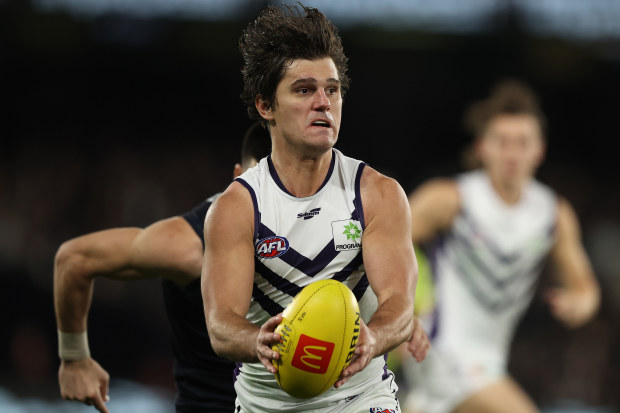 MELBOURNE, AUSTRALIA - JUNE 25: Lachie Schultz of the Dockers runs with the ball during the round 15 AFL match between the Carlton Blues and the Fremantle Dockers at Marvel Stadium on June 25, 2022 in Melbourne, Australia. (Photo by Robert Cianflone/Getty Images)