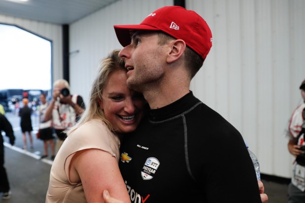 Liz Power (left) celebrates with husband Will after winning the 2019 IndyCar race at Pocono.