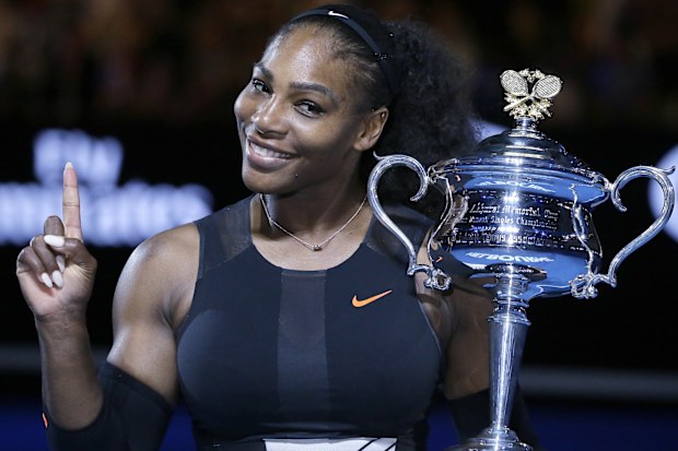In this Jan. 28, 2017, file photo, Serena Williams holds up a finger and her trophy after defeating her sister, Venus, in the women's singles final at the Australian Open tennis championships in Melbourne, Australia. 