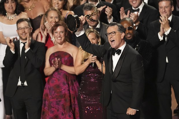 Stephen Colbert, center, and he team from "The Late Show with Stephen Colbert" accept the award for outstanding talk series during the 77th Primetime Emmy Awards on Sunday, Sept. 14, 2025, at the Peacock Theater in Los Angeles. 