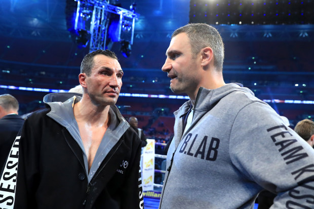 Wladimir Klitschko (L) and his brother Vitali Klitschko speak after defeat to Anthony Joshua at Wembley Stadium. 