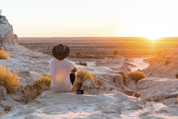 Man watching the sunset at the Walls of China in Mungo National Park, Mungo.