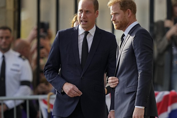 Britain's Prince William, left, and Britain's Prince Harry speak after viewing the floral tributes for the late Queen Elizabeth II outside Windsor Castle, in Windsor, England on Sept. 10, 2022
