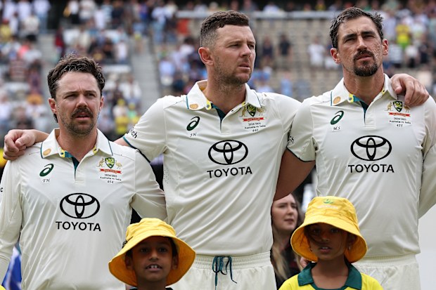 Travis Head, Josh Hazlewood and Mitchell Starc of Australia look on as the national anthem is performed during day one of the first Test match in the series between Australia and India at Perth Stadium on November 22, 2024 in Perth, Australia. (Photo by Paul Kane - CA/Cricket Australia via Getty Images)