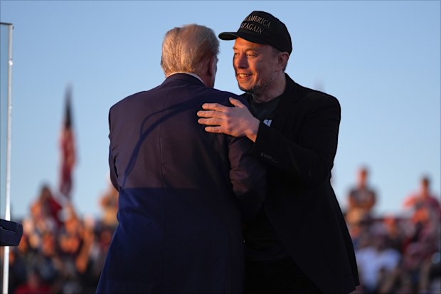 Republican presidential nominee former President Donald Trump hugs Elon Musk at a campaign rally at the Butler Farm Show, Saturday, Oct. 5, 2024, in Butler, Pa. 