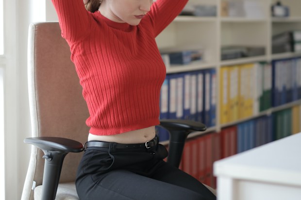 Young female worker in an office. Stock photo.