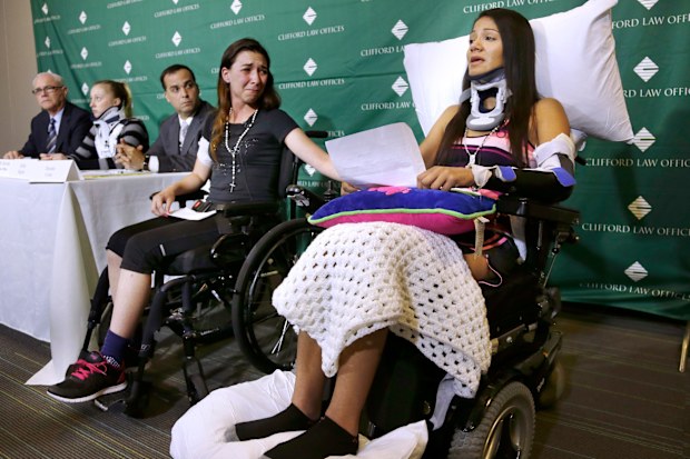 Circus acrobat Julissa Segrera, second from right, of the United States, and Dayana Costa, right, of Brazil, are tearful as Ms Costa reads a statement at Spaulding Rehabilitation Hospital in Boston. They were among the eight acrobats injured when the apparatus from which they were suspended fell, sending them plummeting to the ground during a performance.