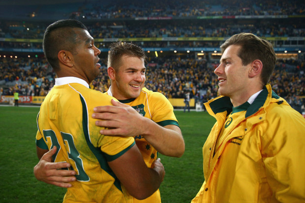 Kurtley Beale (left) and Drew Mitchell (middle) embrace after Australia defeated New Zealand in 2015. 