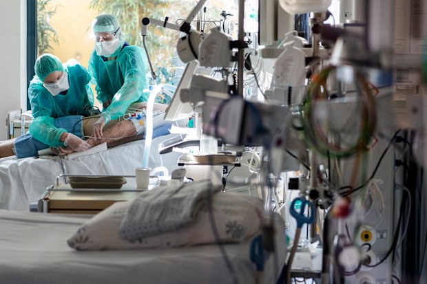 Medical personnel at work in the intensive care unit of the hospital Pourtales site "Hospital Pourtales" during the coronavirus disease (COVID-19) outbreak in Neuchatel, Switzerland, Monday, March 23, 2020. (Jean-Christophe Bott/Keystone via AP)
