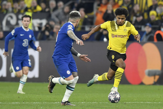 Enzo Fernandez of Chelsea can't deal with Karim Adeyemi of Borussia Dortmund.