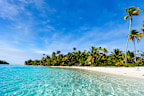 Stunning tropical Aitutaki One Foot island with palm trees, white sand, turquoise ocean water and blue sky at Cook Islands, South Pacific