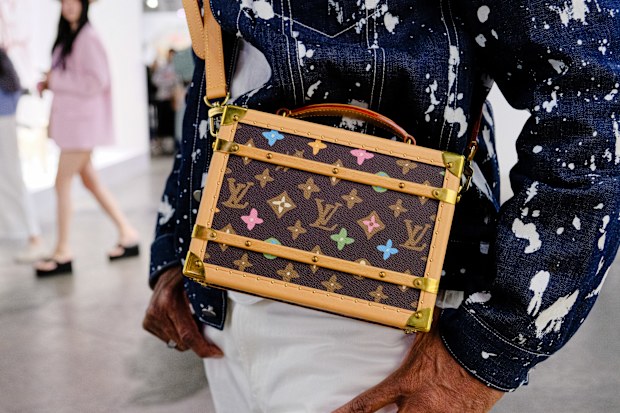 HONG KONG, CHINA - MARCH 29: A visitor wearing Philip Lim jacket, 45R jeans, Louis Vuitton handbag attends Art Basel Hong Kong 2025 at Hong Kong Convention and Exhibition Center on March 29, 2025 in Hong Kong, China. (Photo by Keith Tsuji/Getty Images)