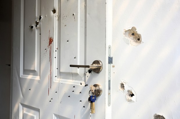 Gunshots and blood stains on a door and walls of a house in a kibbutz where civilians were killed days earlier in an attack by Hamas militants.