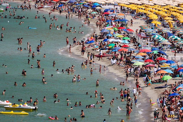 People cool off at Mondello beach, during a heatwave across Italy, in Palermo, Italy.