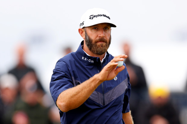 HOYLAKE, ENGLAND - JULY 21: Dustin Johnson of the United States acknowledges the crowd on Day Two of The 151st Open at Royal Liverpool Golf Club on July 21, 2023 in Hoylake, England. (Photo by Andrew Redington/Getty Images)