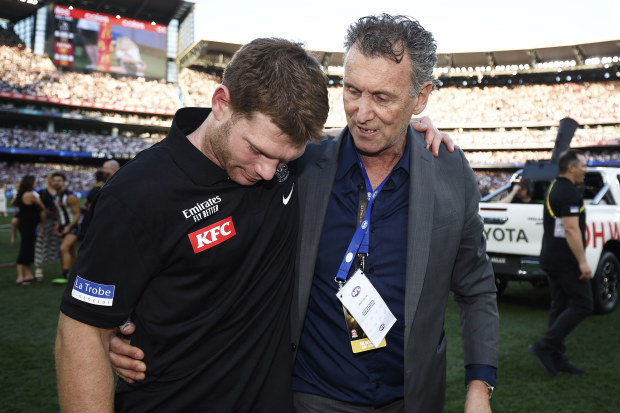 An emotional Adams with Collingwood legend Peter Daicos after the grand final.
