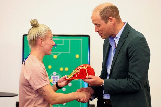 Prince William, Prince of Wales and President of The Football Association, presents a legacy cap to football player Bethany England during a visit to England Women's team to wish them luck ahead of the 2023 FIFA Women's World Cup at St Georges Park on June 20, 2023 in Burton-upon-Trent, England 