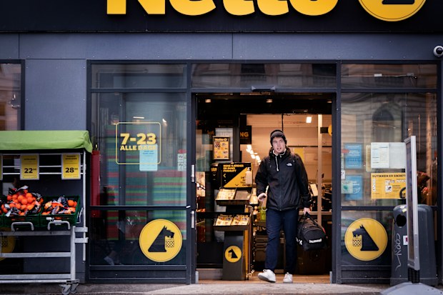 A customer exits a supermarket in Copenhagen, Denmark, Tuesday, February. 1, 2022. 