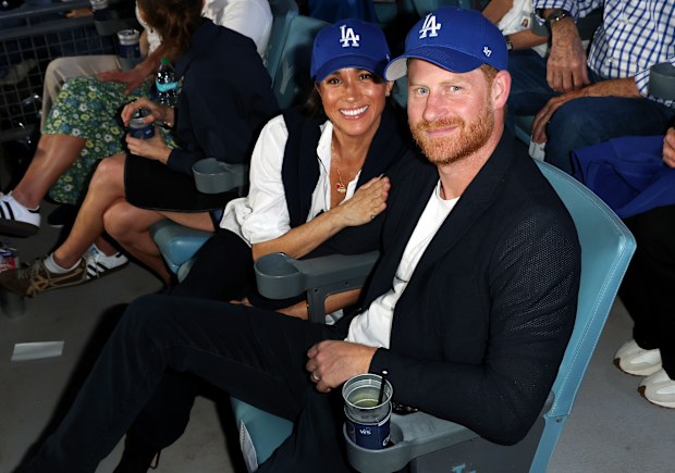 Prince Harry and Meghan Markle, the Duke and Duchess of Sussex, at Game 4 of baseball's World Series between the Los Angeles Dodgers and the Toronto Blue Jays in Los Angeles, Tuesday, Oct. 28, 2025. 