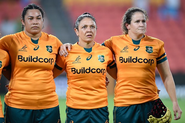 Liz Patu (from left), Iliseva Batibasaga and Shannon Parry of the Wallaroos stand together during the national anthem.