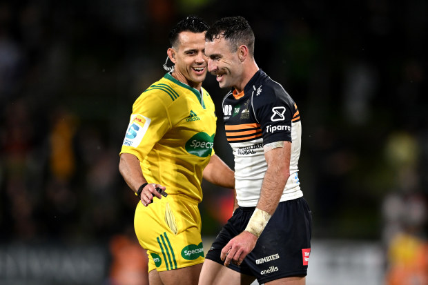 Nic White of the Brumbies laughs with referee Nic Berry.