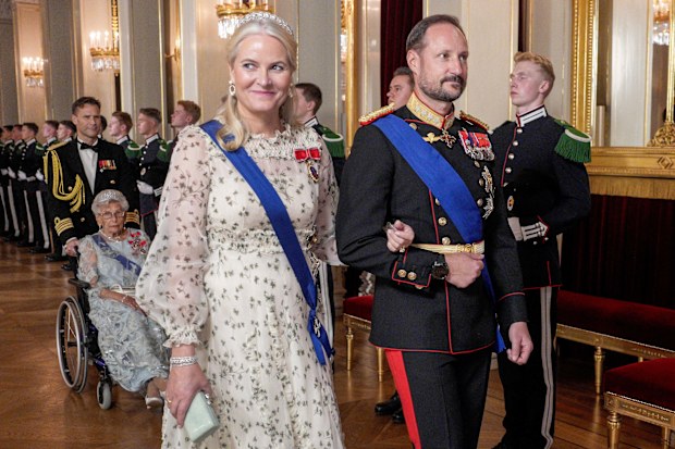 Crown Princess Mette-Marit, front left, and Crown Prince Haakon, front right, on their way to the gala dinner at the Royal Palace in Oslo, Norway, Tuesday, Oct. 15, 2024. (Javad Parsa/Pool Photo via AP)