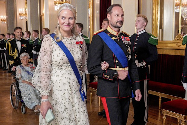 Crown Princess Mette-Marit, front left, and Crown Prince Haakon, front right, on their way to the gala dinner at the Royal Palace in Oslo, Norway, Tuesday, Oct. 15, 2024. (Javad Parsa/Pool Photo via AP)