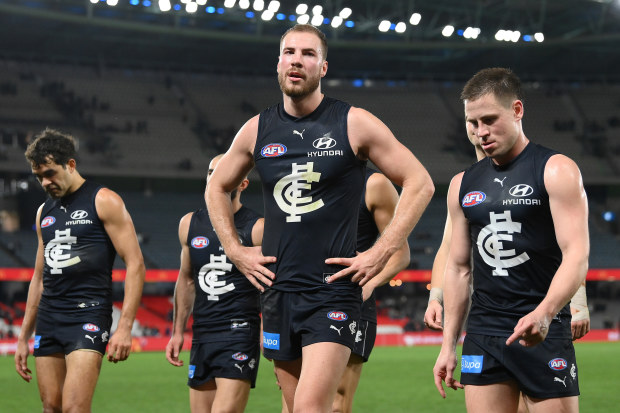 MELBOURNE, AUSTRALIA - AUGUST 27: Harry McKay and his Blues team mates look dejected after losing the round 24 AFL match between Carlton Blues and Greater Western Sydney Giants at Marvel Stadium, on August 27, 2023, in Melbourne, Australia. (Photo by Quinn Rooney/Getty Images)