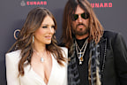 Elizabeth Hurley and Billy Ray Cyrus pose for photographers upon arrival at the Olivier Awards in London, England, Sunday, April 12, 2026. (Photo by Scott A Garfitt/Invision/AP)