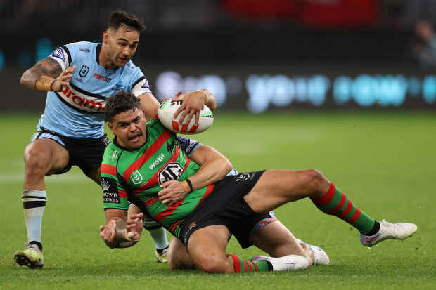 Latrell Mitchell of the Rabbitohs gets tackled by Nicholas Hynes of the Sharks during the round 23 NRL match between South Sydney Rabbitohs and Cronulla Sharks at Optus Stadium on August 05, 2023 in Perth, Australia. (Photo by Paul Kane/Getty Images)