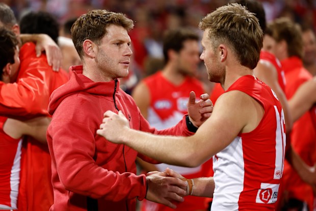 Taylor Adams of the Swans and Braeden Campbell celebrate their preliminary final win.