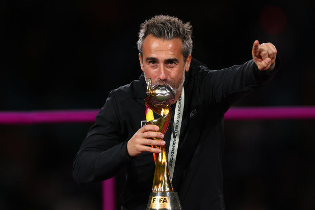 Jorge Vilda celebrates by kissing a trophy after Spain won the FIFA Women's World Cup.