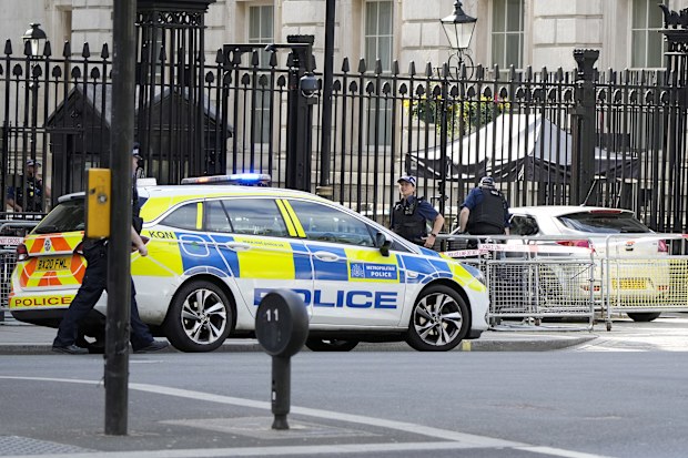 Police at the scene after a car collided with the gates of Downing Street in London in London, Thursday, May 25, 2023. 