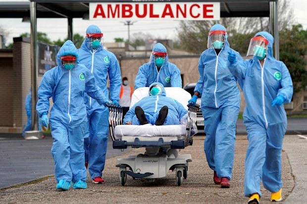 A person is taken on a stretcher into the United Memorial Medical Centre after going through testing for COVID-19 Thursday, March 19, 2020, in Houston. Picture: David J. Phillip