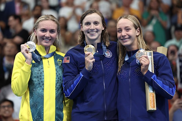 Gold Medalist Katie Ledecky of Team United States (C), Silver Medalist Ariarne Titmus of Team Australia (L) and Bronze Medalist Paige Madden of Team United States (R) pose on the podium during the Swimming medal ceremony after the Women's 800m Freestyle Final on day eight of the Olympic Games Paris 2024 at Paris La Defense Arena on August 03, 2024 in Nanterre, France. 