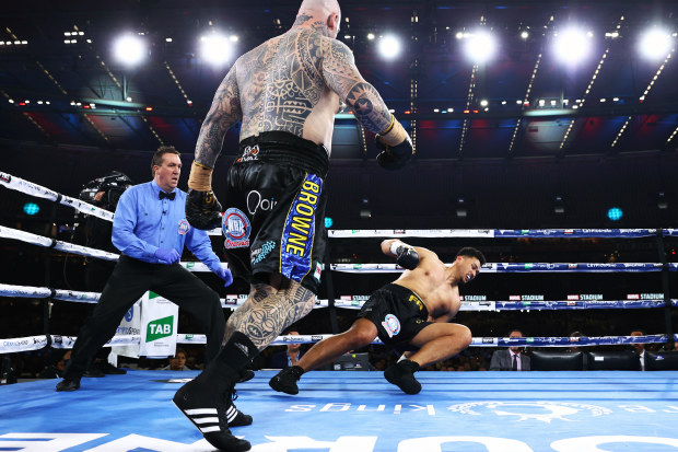  Lucas Browne knocks down Junior Fa during their heavyweight fight, at Marvel Stadium.