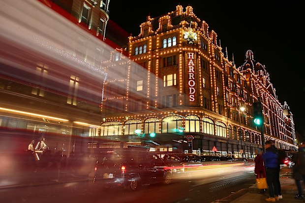 A London bus passes Harrods in Knightsbridge on December 12, 2020 in London, England.