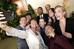 <p>The 10 cast members took a moment before the event to take a truly iconic selfie together.</p><p>Isaacs even appeared to give Schwarzenegger a wet willy as he took the photo.</p>