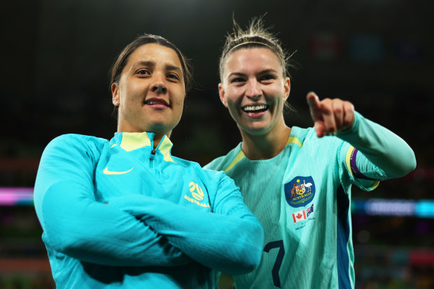 MELBOURNE, AUSTRALIA - JULY 31: Sam Kerr and Steph Catley of Australia applaud fans after the team's 4-0 victory and qualification for the knockout stage following the FIFA Women's World Cup Australia & New Zealand 2023 Group B match between Canada and Australia at Melbourne Rectangular Stadium on July 31, 2023 in Melbourne, Australia. (Photo by Alex Pantling - FIFA/FIFA via Getty Images)