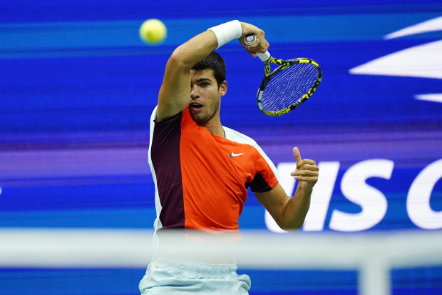 Carlos Alcaraz of Spain returns a shot to Frances Tiafoe of the United States.