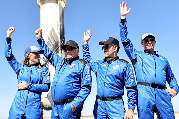 VAN HORN, TEXAS - OCTOBER 13: (L-R) Blue Origins vice president of mission and flight operations Audrey Powers, Star Trek actor William Shatner, Planet Labs co-founder Chris Boshuizen and Medidata Solutions co-founder Glen de Vries wave during a media availability on the landing pad of Blue Origins New Shepard after they flew into space on October 13, 2021 near Van Horn, Texas. Shatner became the oldest person to fly into space on the ten minute flight. They flew aboard mission NS-18, the second