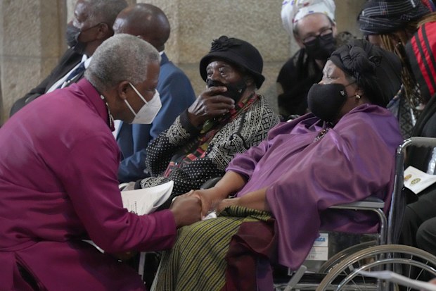 Anglican Archbishop of Cape Town, Thabo Makgoba, left, widow Leah Tutu at the funeral of Anglican Archbishop Emeritus Desmond Tutu   in St. Georges Cathedral in Cape Town, South Africa, Saturday, Jan. 1, 2022. 