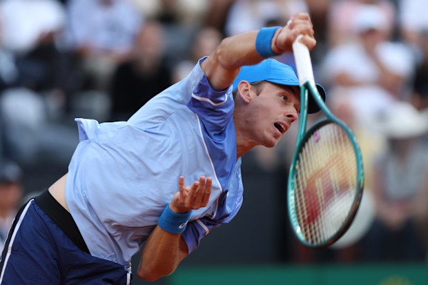 Alex de Minaur of Australia serves against Stefanos Tsitsipas of Greece in Rome.